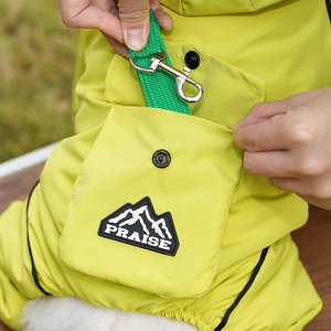 Close-up of waterproof dog coat featuring a mountain logo pocket and metal leash D-ring