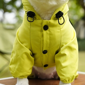 Detail of yellow waterproof dog jacket featuring snap buttons and adjustable drawstring