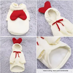Detail view of cream pet hoodie with fleece lining and red heart pattern for warmth