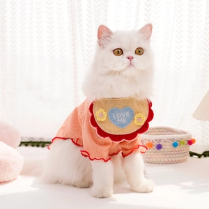 Détail du bavoir rose tricoté pour animaux avec bords rouges et broderie cœur LOVE ME