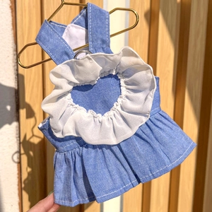 Close-up of pet denim dress featuring a white heart ruffle and metallic D-ring