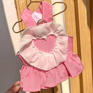 Detailed view of pink pet dress with heart-shaped ruffle back and metal D-ring attachment