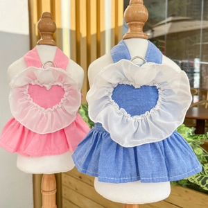 Detail view of denim pet dresses with heart-shaped tulle ruffles and metal D-rings