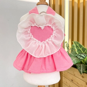 Detailed view of pink pet dress with white mesh heart ruffles and metal D-ring attachment