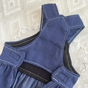 Detail of durable blue denim pet dress with fine white double-stitching and elastic strap