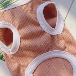 Close-up of pink pet vest featuring waffle knit texture and ribbed hem detail