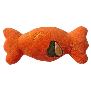 Candy-shaped plush squeaky pet toy in orange featuring sugar embroidery and avocado