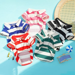 Flat lay of colorful striped pet polo shirts with summer beach vacation props