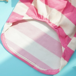 Detail of pink and white striped pet clothing showing breathable pique knit fabric quality