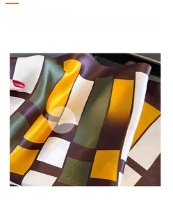 Detailed view showing the silky texture and drape of geometric pattern silk scarf