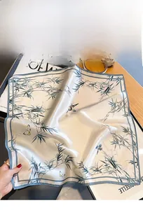 Detailed view of 100% mulberry silk scarf with vintage bamboo and butterfly prints