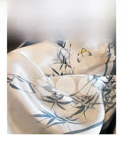 Macro shot of 100% silk scarf with green bamboo and yellow butterfly ink painting