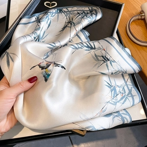 Elegant 100% mulberry silk square scarf featuring blue bamboo leaves and a butterfly
