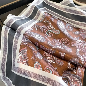 Silk square scarf featuring vintage paisley patterns and elegant striped borders