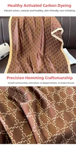 Detail of coffee silk scarf with clover pattern showing neat stitching and smooth texture