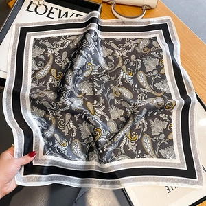 Detail showing paisley silk scarf with yellow accents on a white decorative background