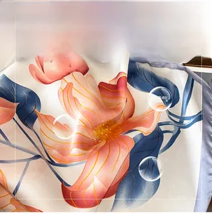 Close-up of soft satin beach shawl featuring peach floral prints and silky texture