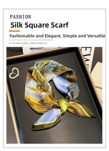 Detail of oil painting style mulberry silk square scarf on a black leather tray