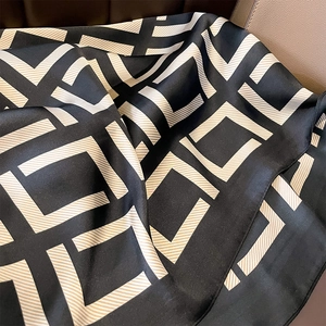 Elegant silk-like scarf with geometric pattern in black and beige gold glossy finish
