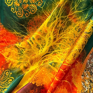 Elegant printed silk scarf featuring green and orange baroque patterns with satin finish