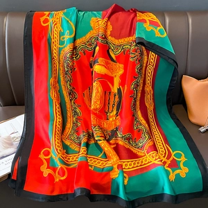 Elegant silk-feel scarf with vintage floral harness patterns on a red and green background