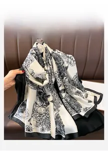 Close-up of black and white vintage floral silk scarf with elegant satin finish