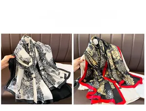 Close-up of lightweight floral silk scarves with delicate prints and glossy texture
