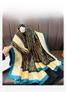 Detail of vintage geometric Greek pattern silk scarf in black, orange and green
