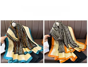 Detail of silk-like satin scarves featuring geometric prints in various color palettes