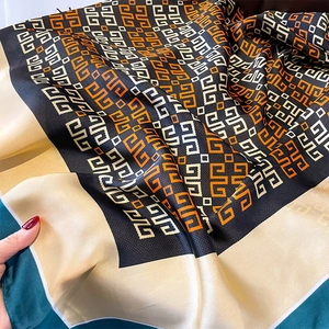 Silk-like geometric G-pattern scarf in navy and orange, elegant draped wrap shawl for women