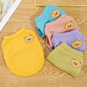 Close-up of soft waffle knit dog t-shirts with cute cartoon bear patch embroidery