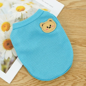 Close-up of sky blue waffle fabric pet vest featuring a cute yellow bear patch detail