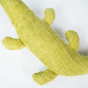 Close-up of green plush crocodile pet toy with durable textured woven fabric details
