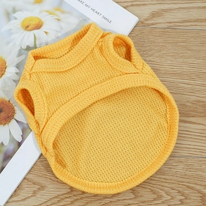 Detail of yellow waffle knit fabric texture on a soft sleeveless pet vest for dogs
