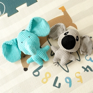 Detail showing plush elephant and koala toys with corduroy texture on play mat