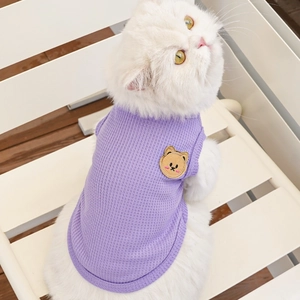 Detail of lavender waffle knit pet vest with cute bear embroidery on a white cat