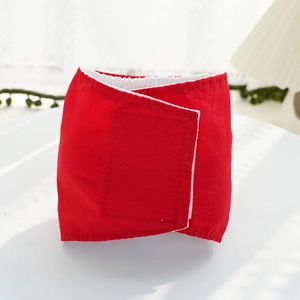 Close-up of red dog belly band featuring durable fabric and adjustable velcro closure
