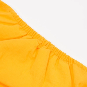 Close-up of bright orange dog belly band featuring elasticated edges and fine stitching