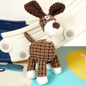 Detail of plush dog toy with cotton rope and textured brown corduroy fabric on a play mat