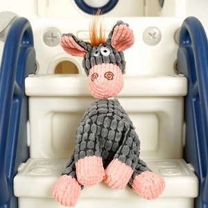 Detailed close-up of a plush donkey dog toy with textured corduroy fabric on a slide