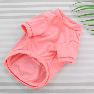 Pink cotton pet T-shirt for small dogs and cats displayed on a striped background