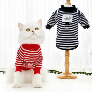 Close-up of striped pet sweater with metal D-ring and happy life patch detail