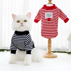 Detail of striped pet sweater featuring a metal D-ring for leash and ribbed turtleneck