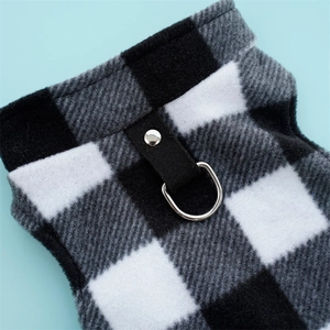 Detail of checkered pet fleece vest showing a silver D-ring and reinforced black strap