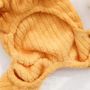 Detail of yellow flannel pet clothes showing striped texture and thick warm lining