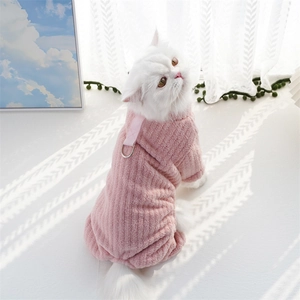 Detailed view of pink flannel pet jumpsuit with D-ring harness on a white cat