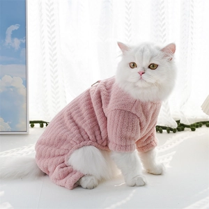 Close-up of pink flannel pet pajamas showing soft striped texture on a white cat
