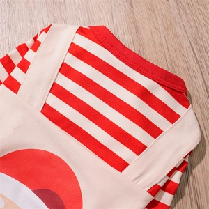 Close-up of red and white striped Christmas pet clothes with beige knit texture details