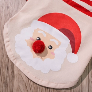 Detail of Christmas dog bib with cartoon Santa print and a 3D red plush pom-pom