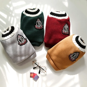Detail of four colors knit pet vests with V-neck stripe and crown embroidery badge